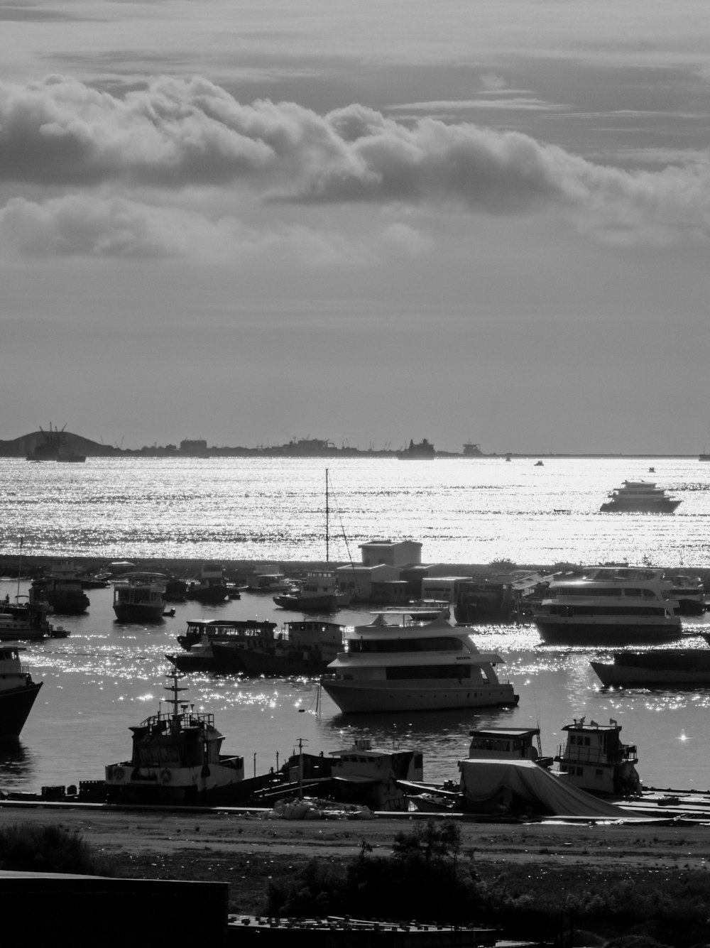 a black and white photo of boats in the water