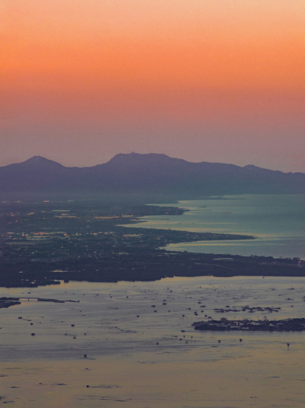 a view of a body of water with mountains in the background