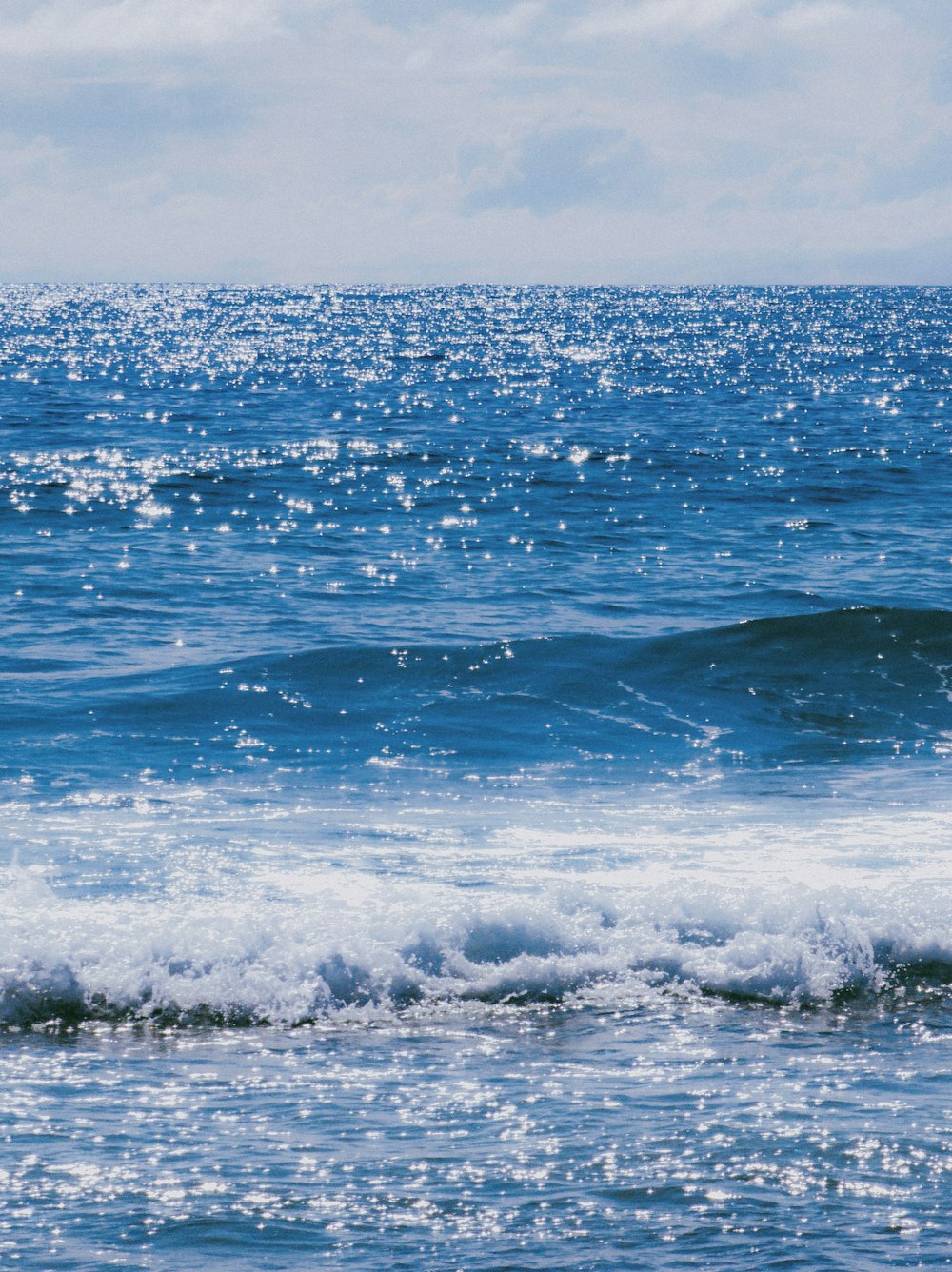 a man riding a wave on top of a surfboard