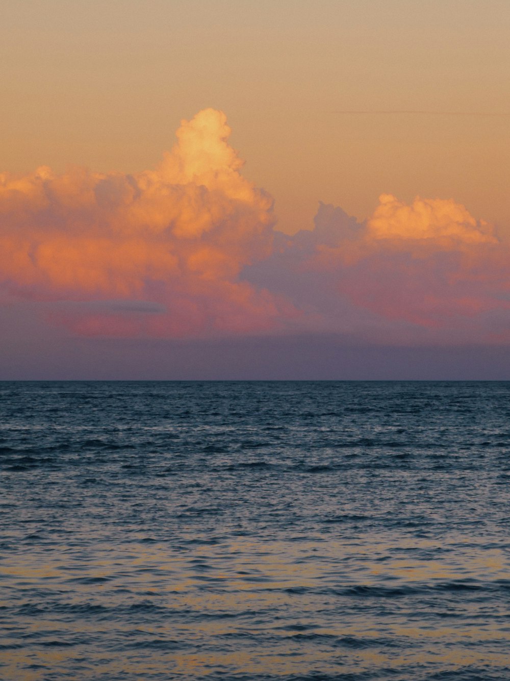 a large body of water under a cloudy sky