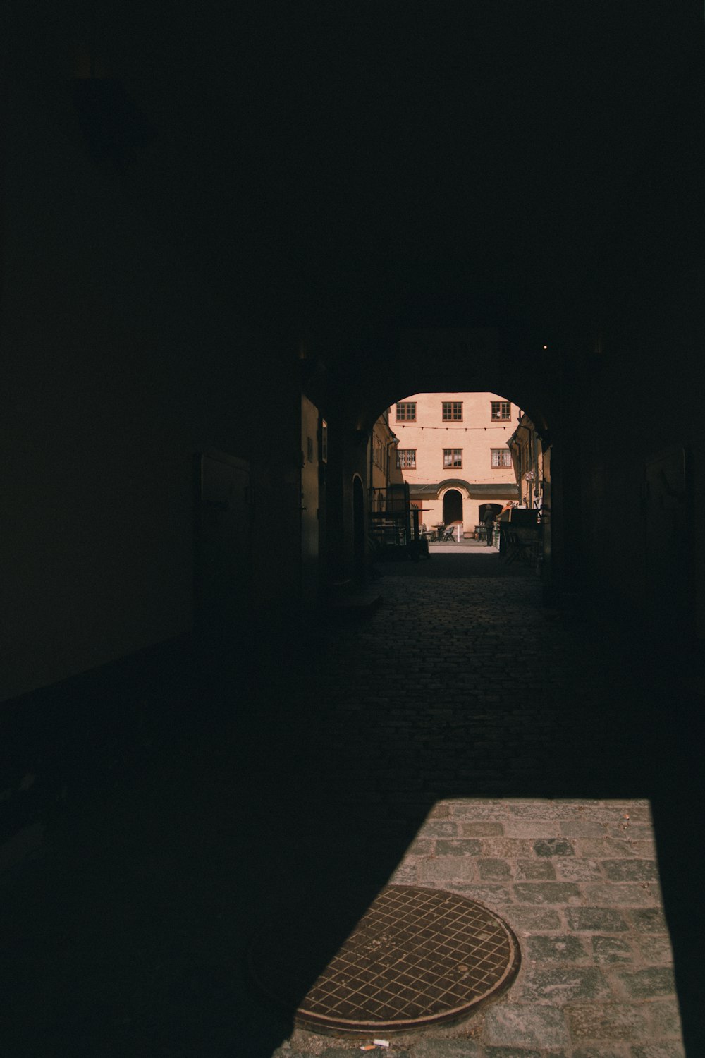 a dark tunnel with a clock on the side of it