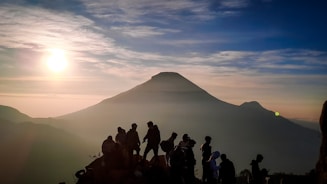 a group of people standing on top of a mountain