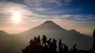 a group of people standing on top of a mountain