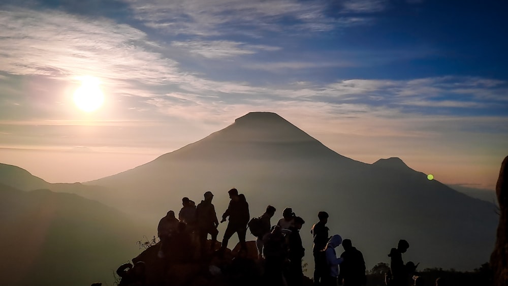 a group of people standing on top of a mountain