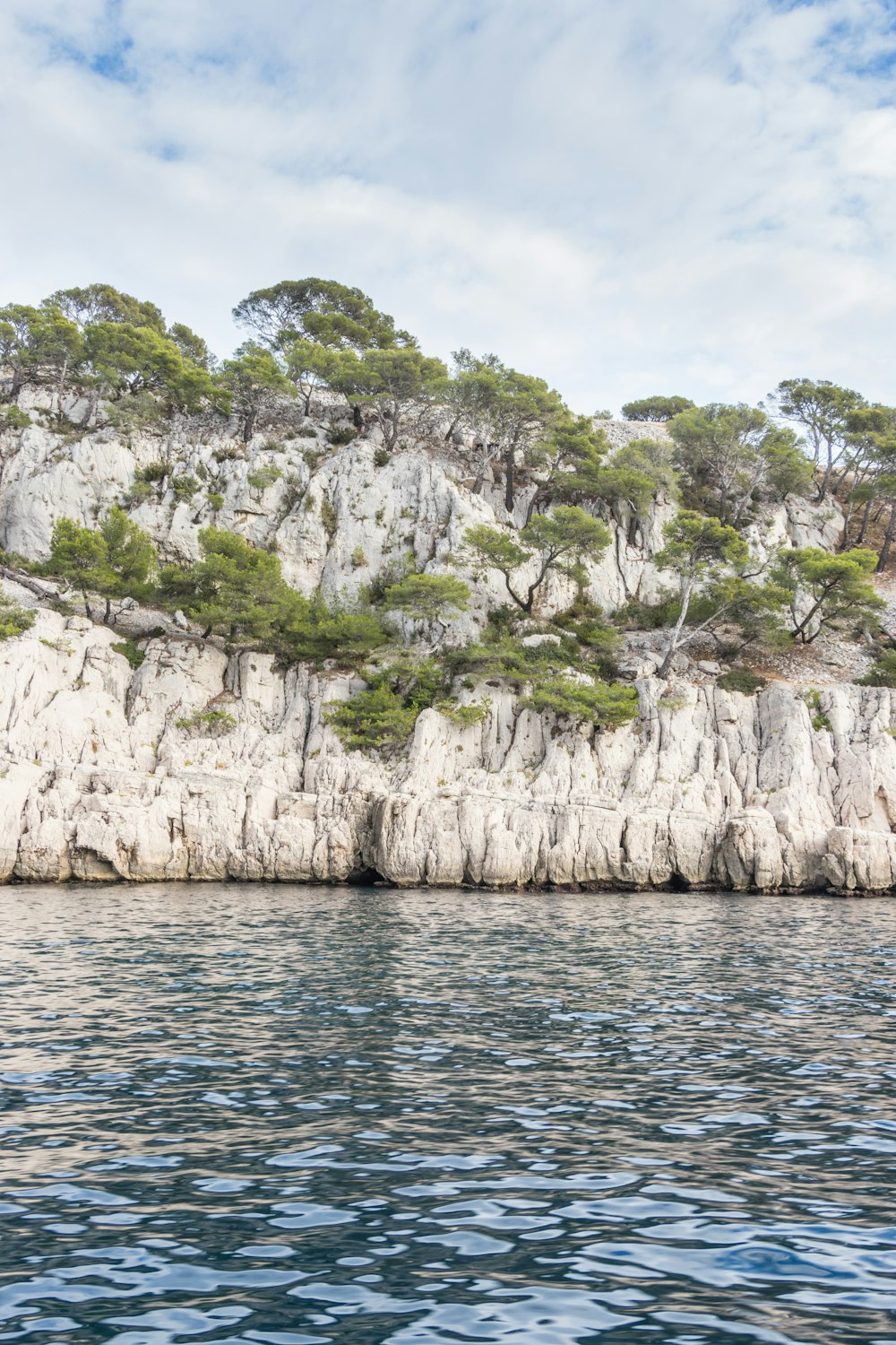 a large body of water next to a rocky cliff