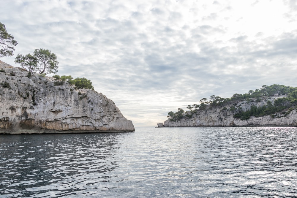 a body of water surrounded by rocky cliffs