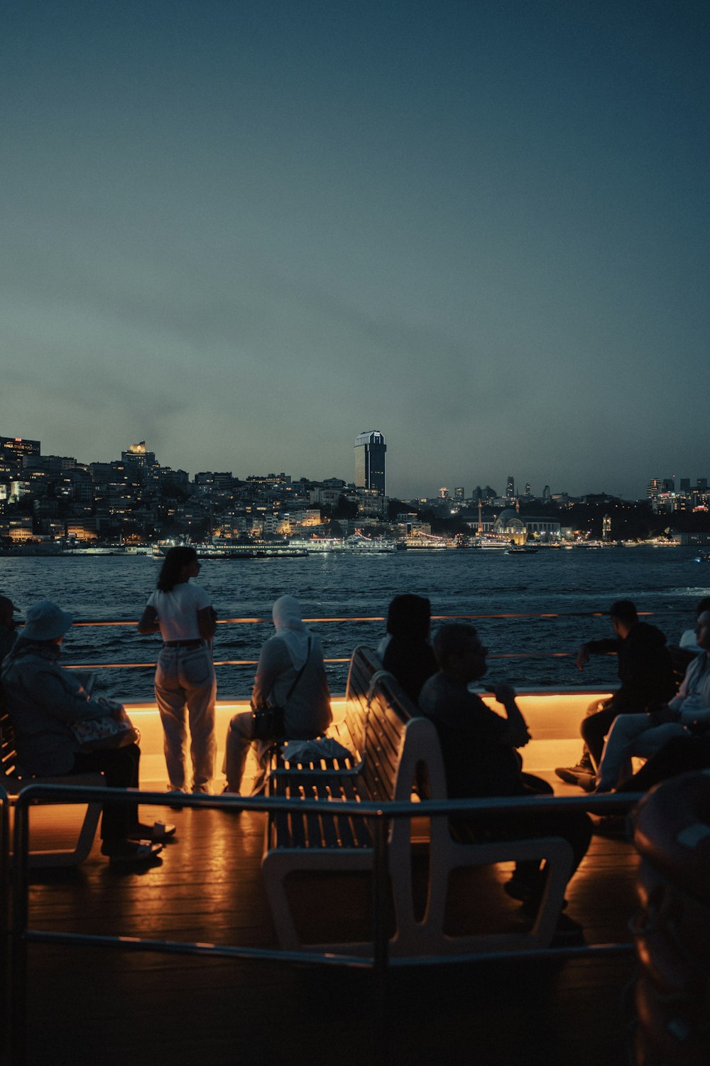 a group of people sitting on top of a boat