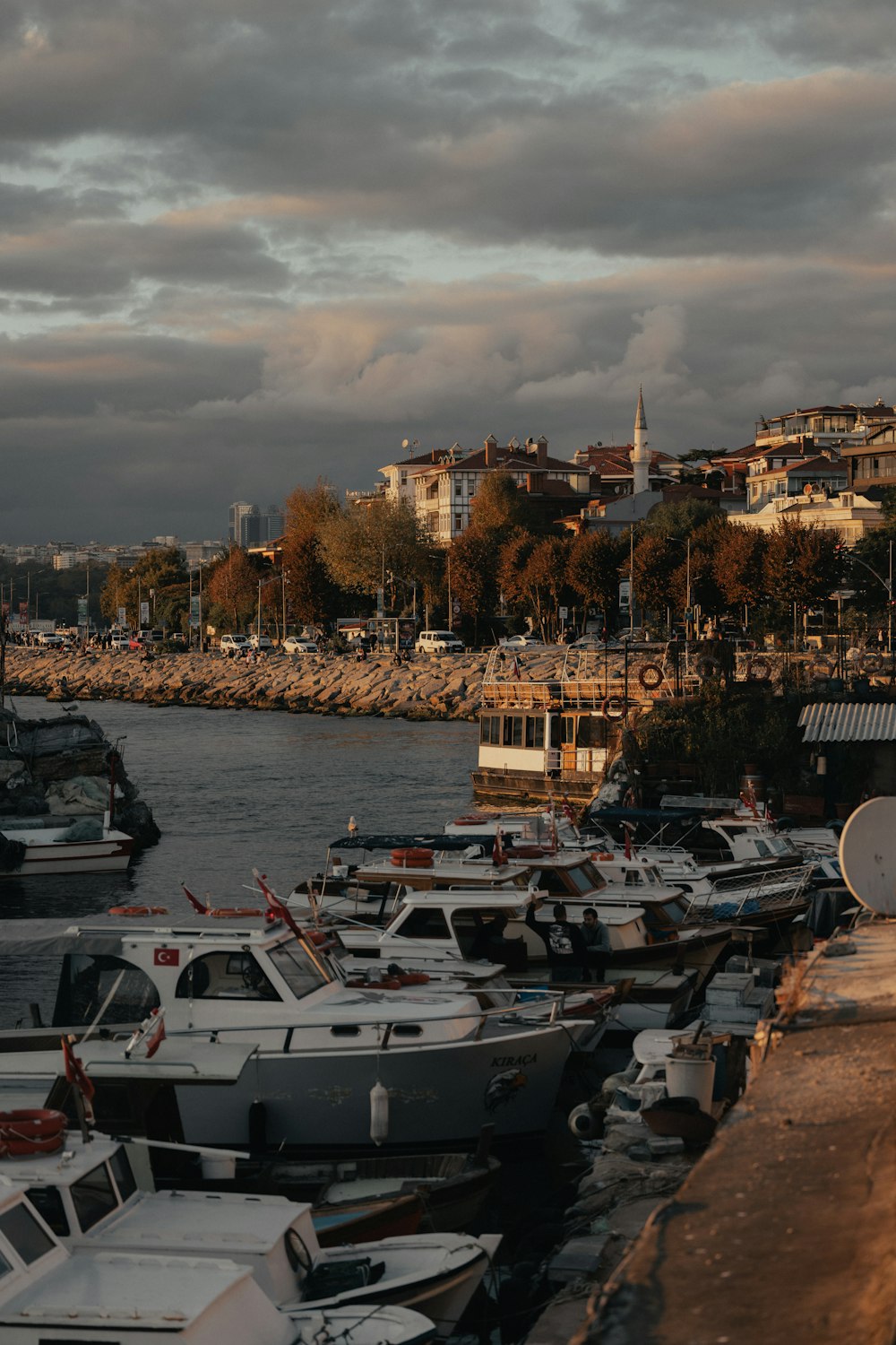 a harbor filled with lots of boats under a cloudy sky