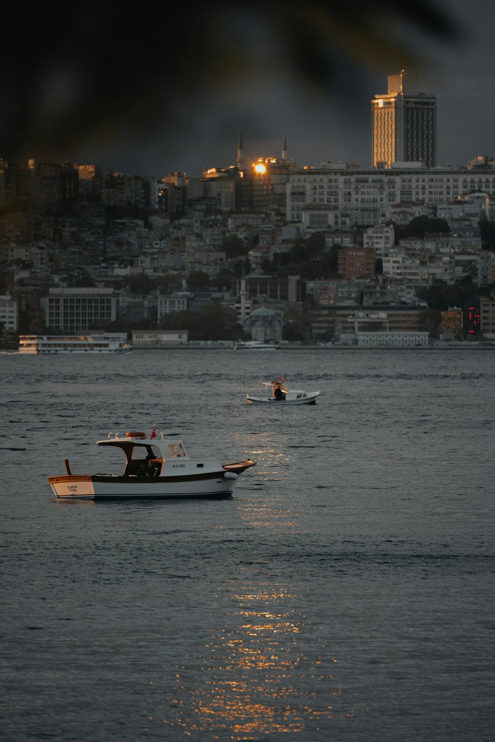 a couple of boats floating on top of a large body of water