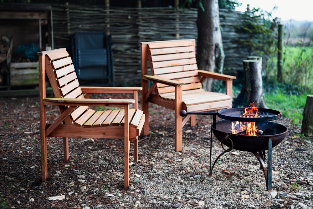 a couple of chairs sitting next to a fire pit