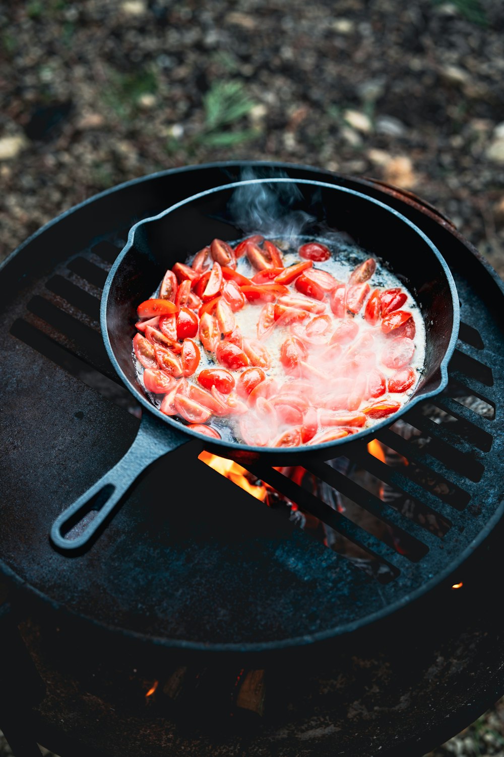 a frying pan filled with food on top of a grill