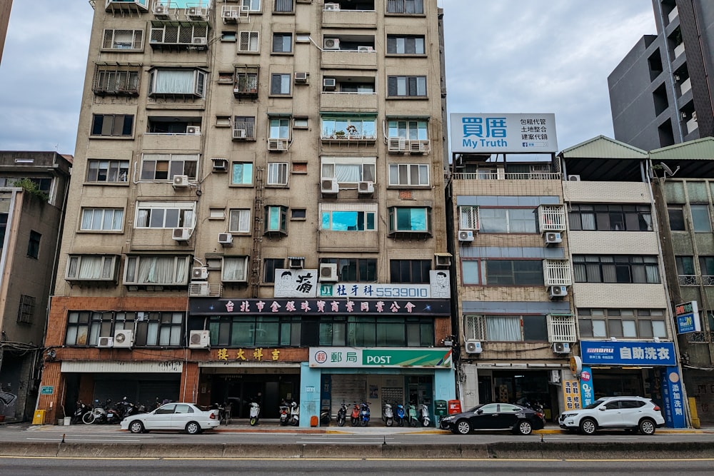 a tall building with lots of windows next to a street