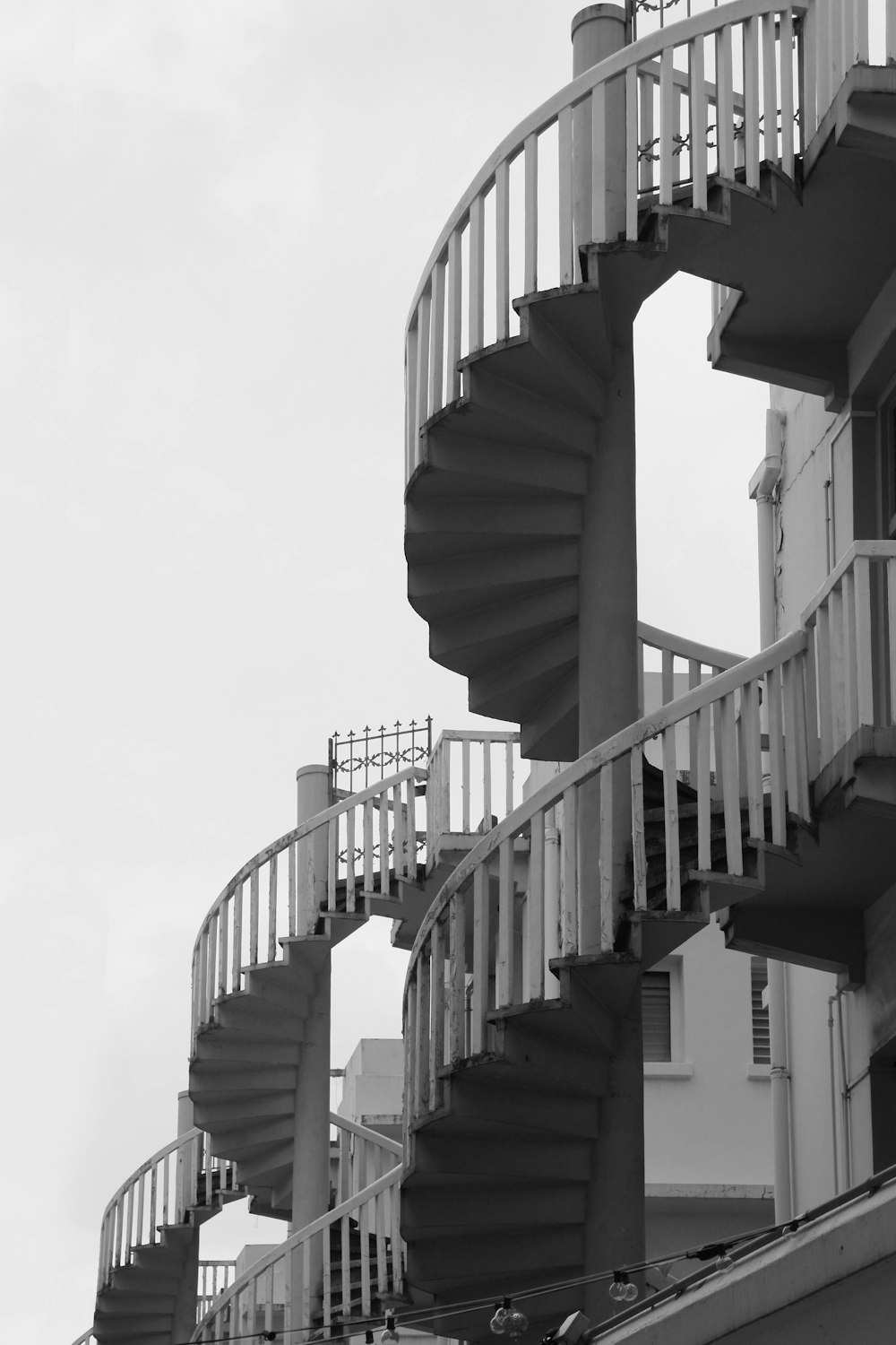 a black and white photo of a spiral staircase