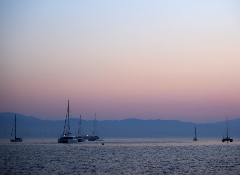 a group of boats floating on top of a large body of water