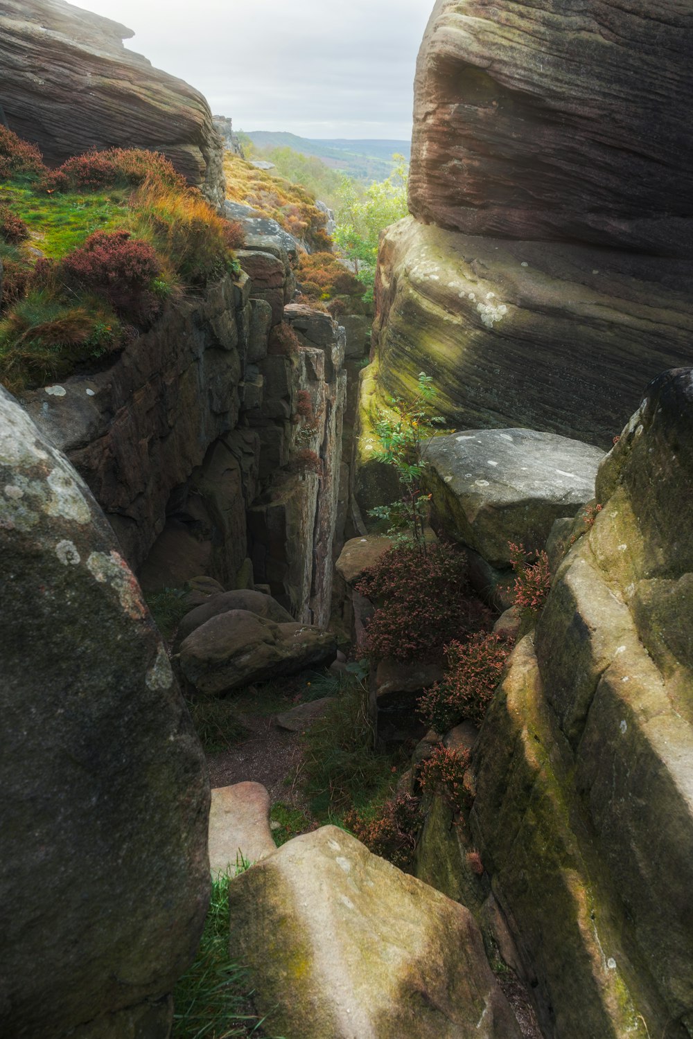 a rocky cliff with a small waterfall in the middle of it