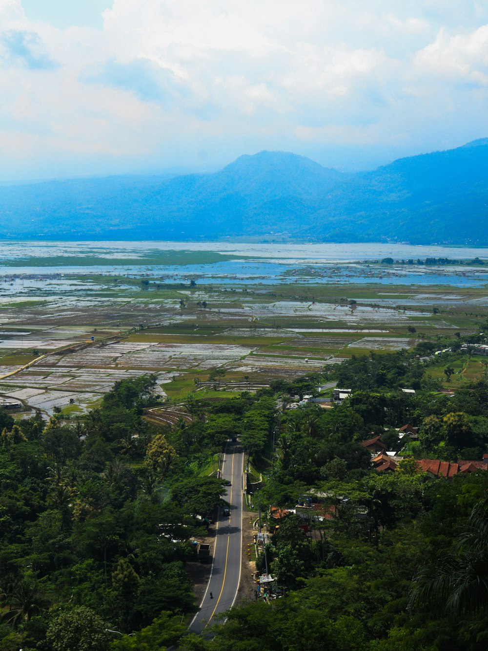 a scenic view of a road and a body of water