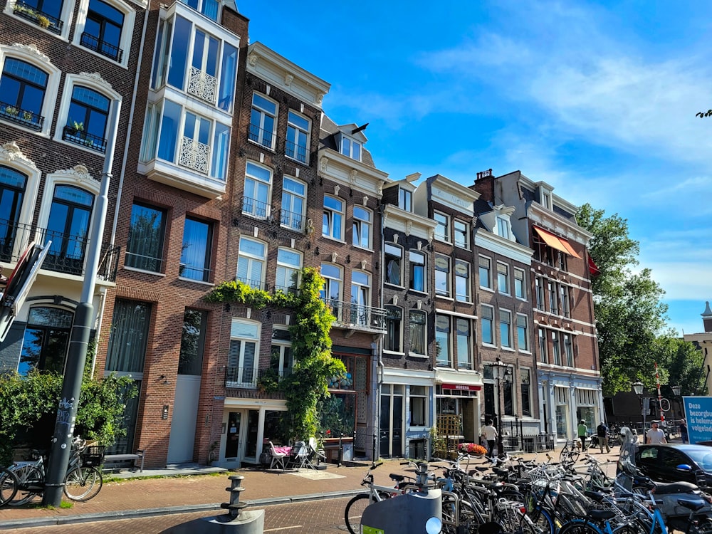 a row of buildings with bicycles parked in front of them