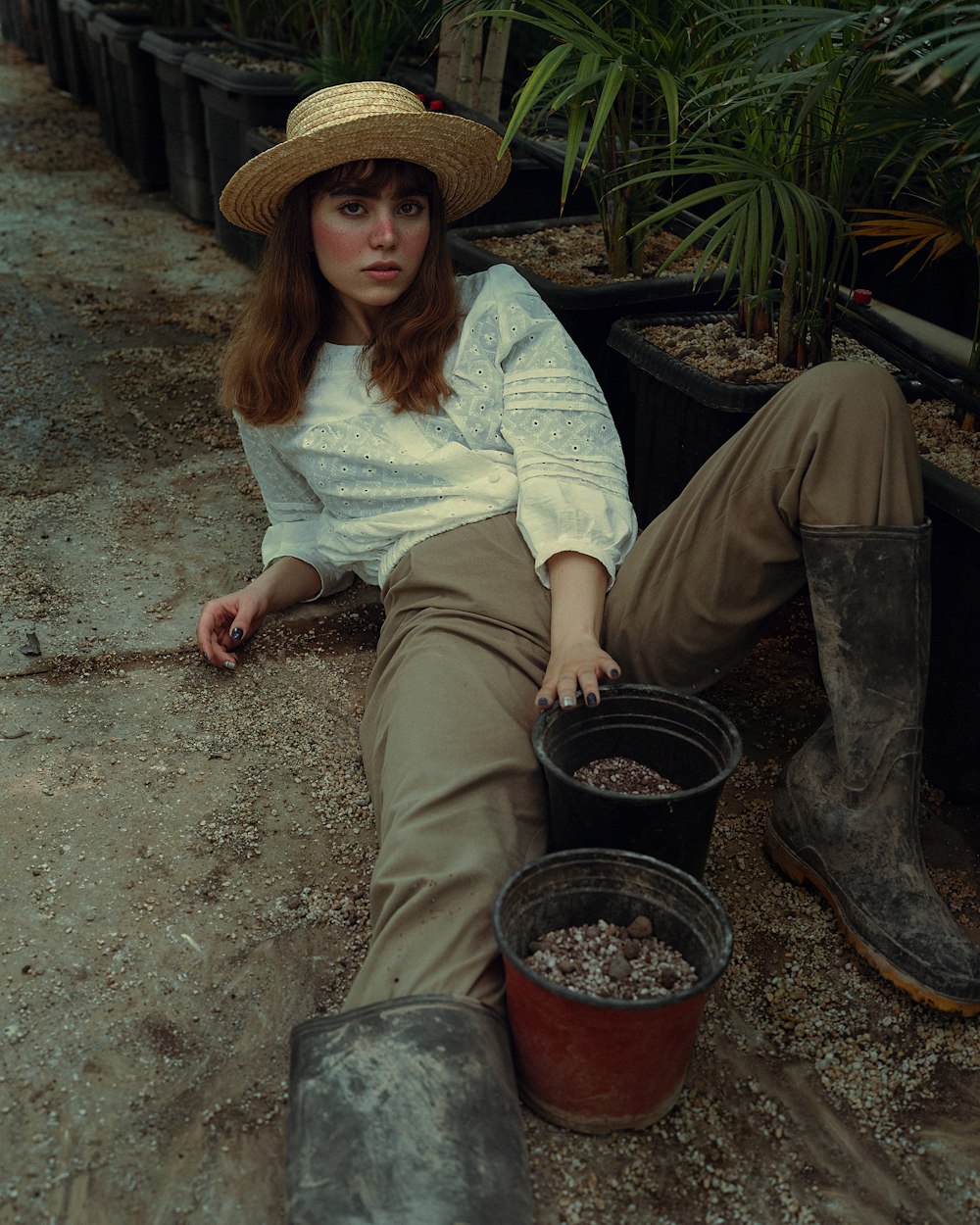 a woman sitting on the ground with two buckets