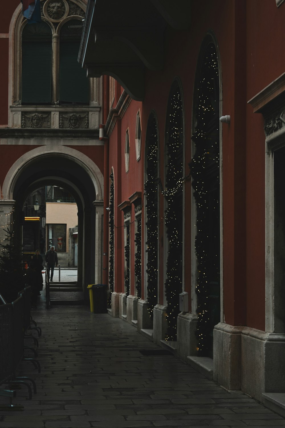 a person walking down a street next to a building
