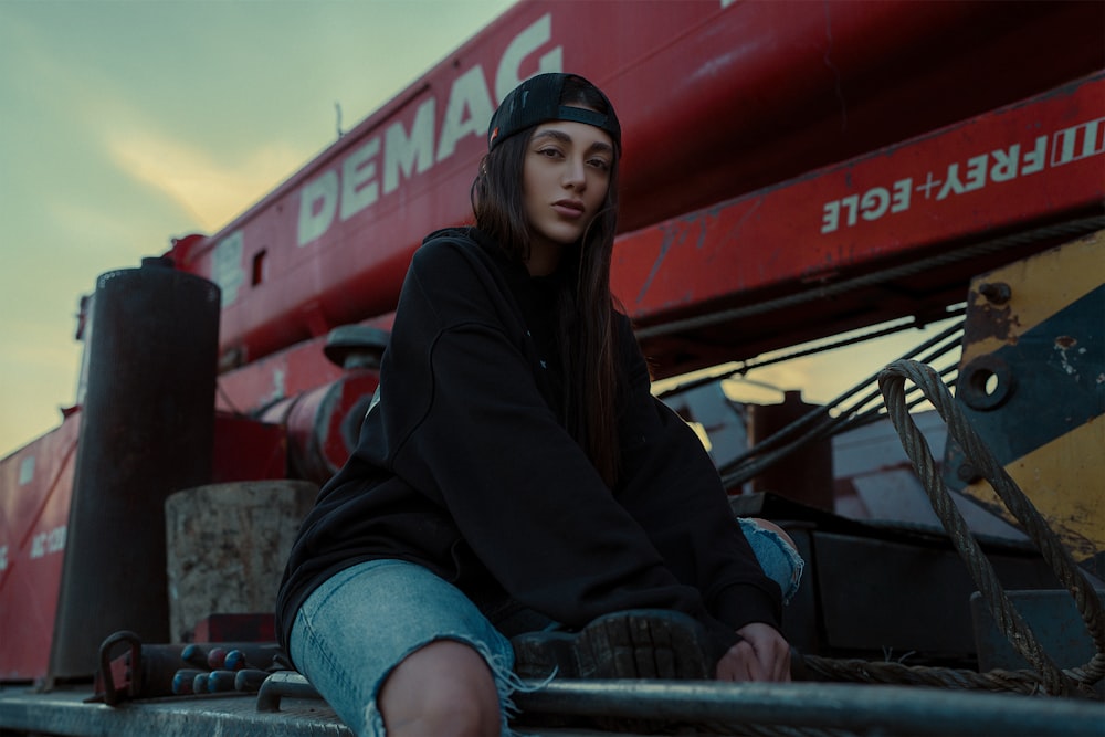 a woman sitting on the back of a truck