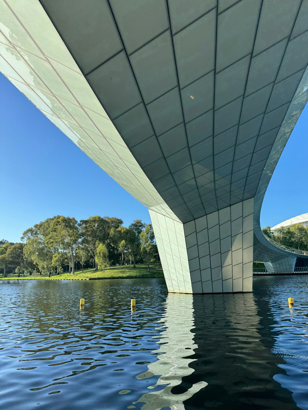 a view of the underside of a bridge over a body of water