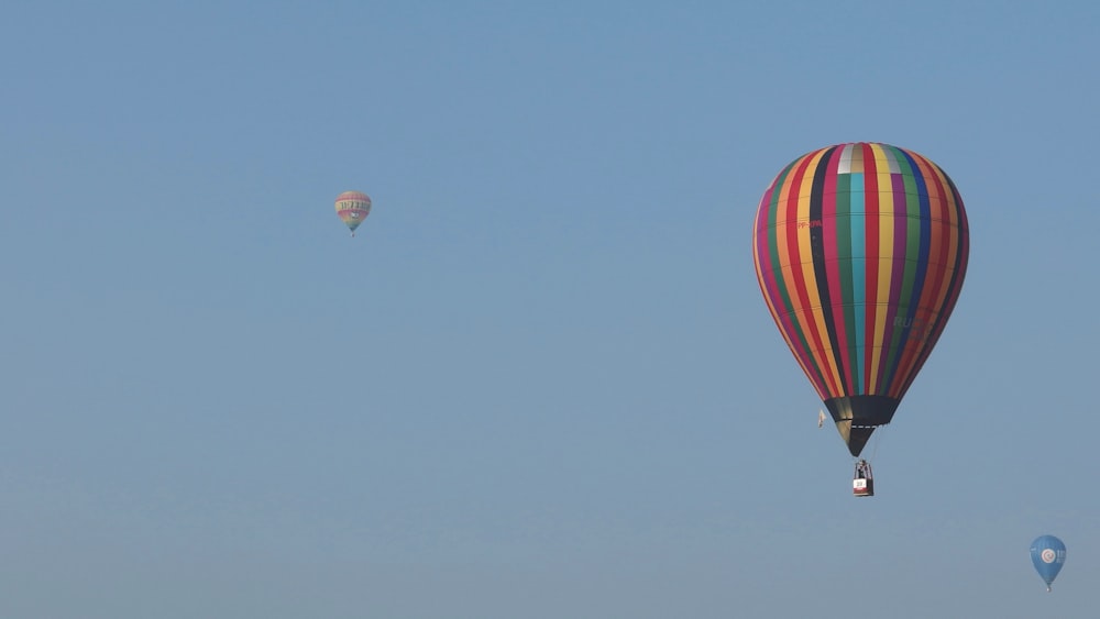 a couple of hot air balloons flying in the sky