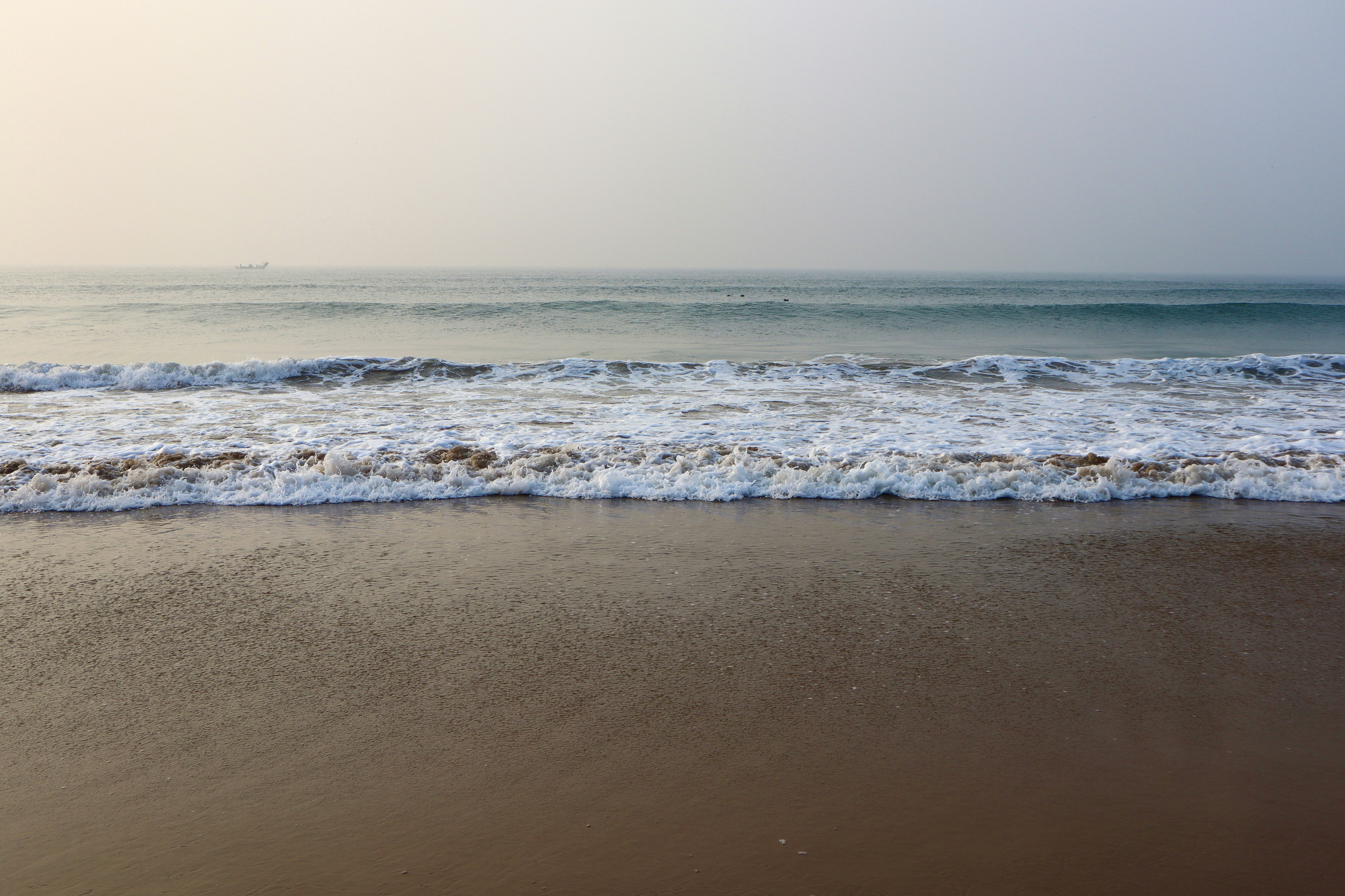 a beach with waves coming in to shore