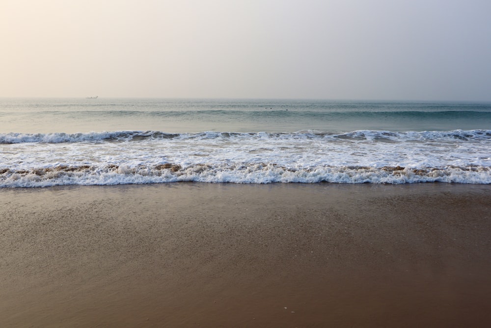 a beach with waves coming in to shore