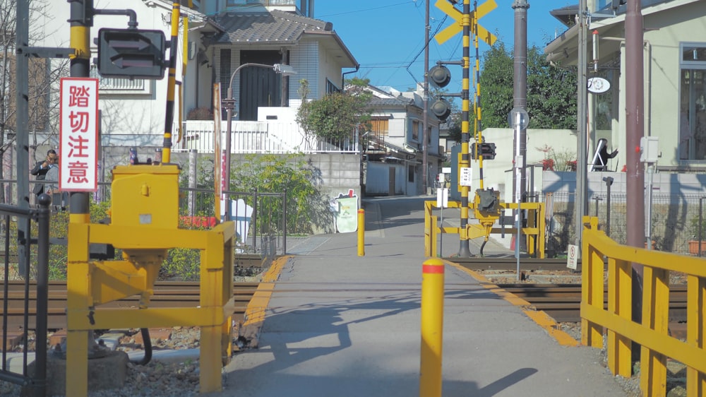 a yellow gate is on the side of the road