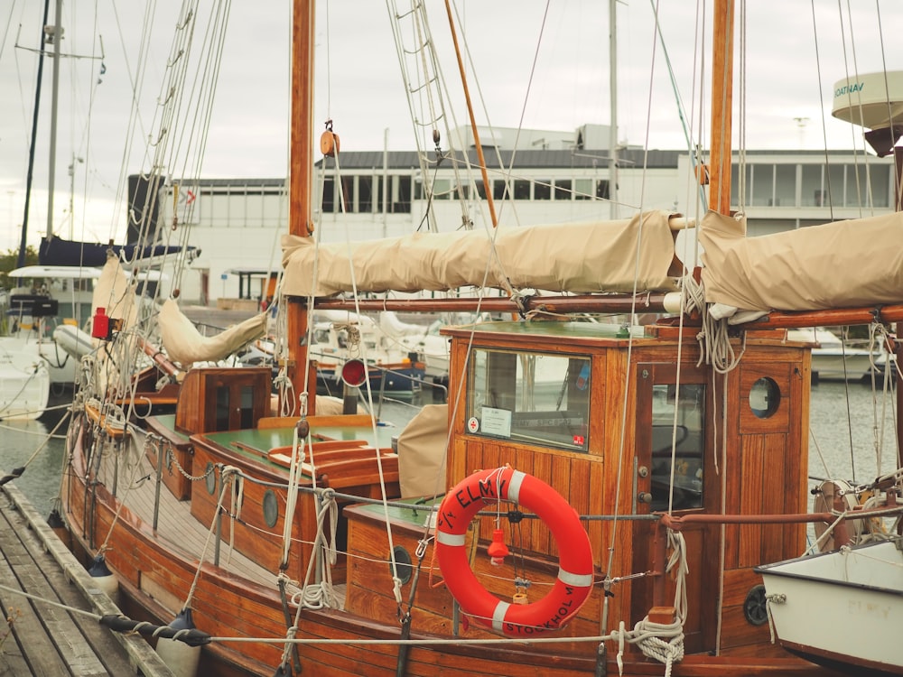 a boat docked at a dock with a life preserver