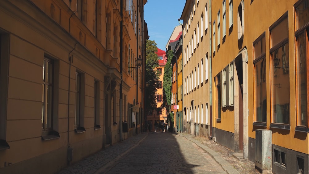 a narrow city street lined with tall buildings