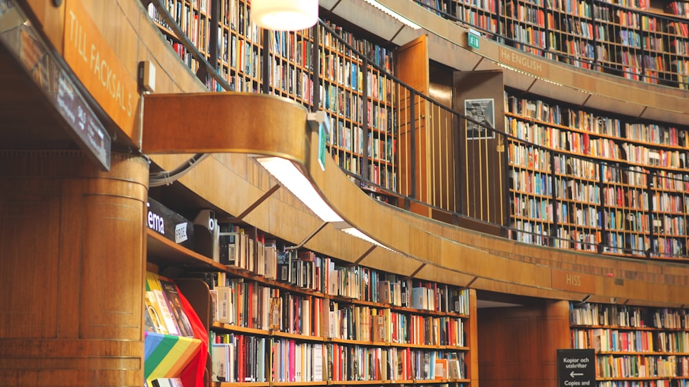 a library filled with lots of books next to a staircase