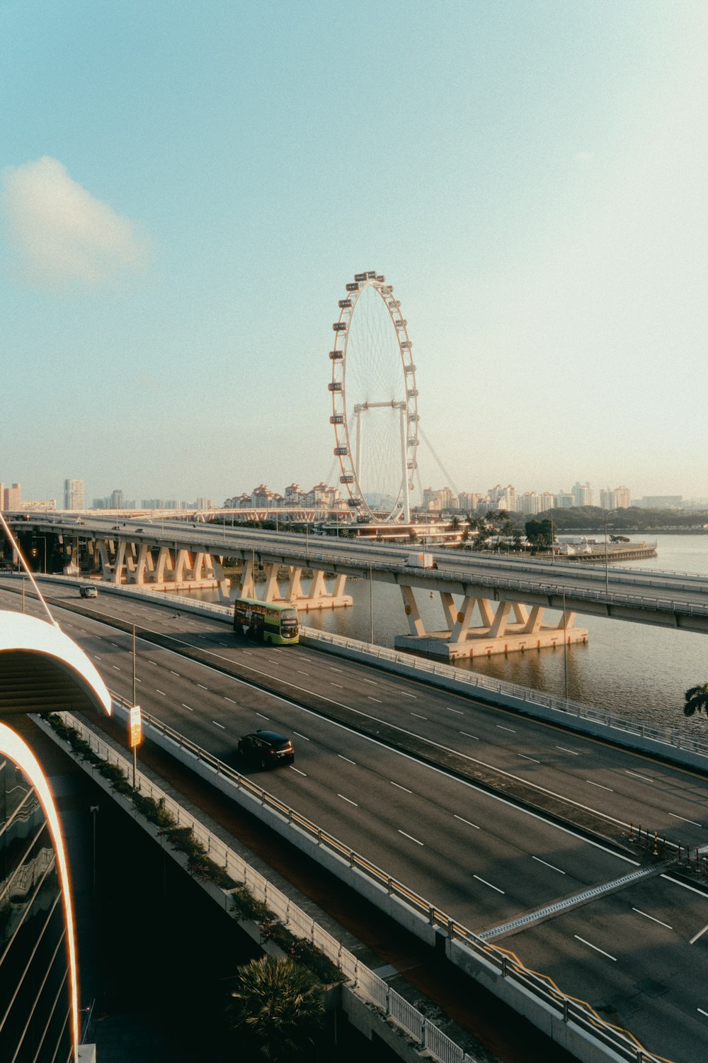 a view of a bridge and a ferris wheel in the distance