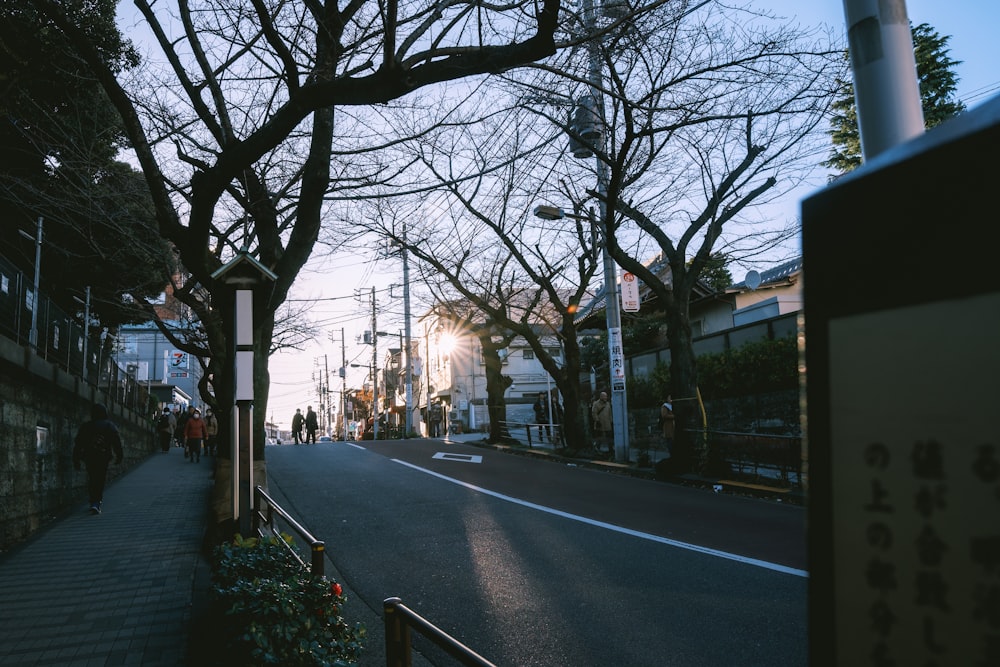 a city street with people walking on the sidewalk