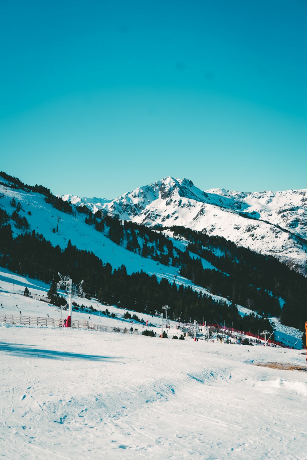 a person on skis in the snow with mountains in the background