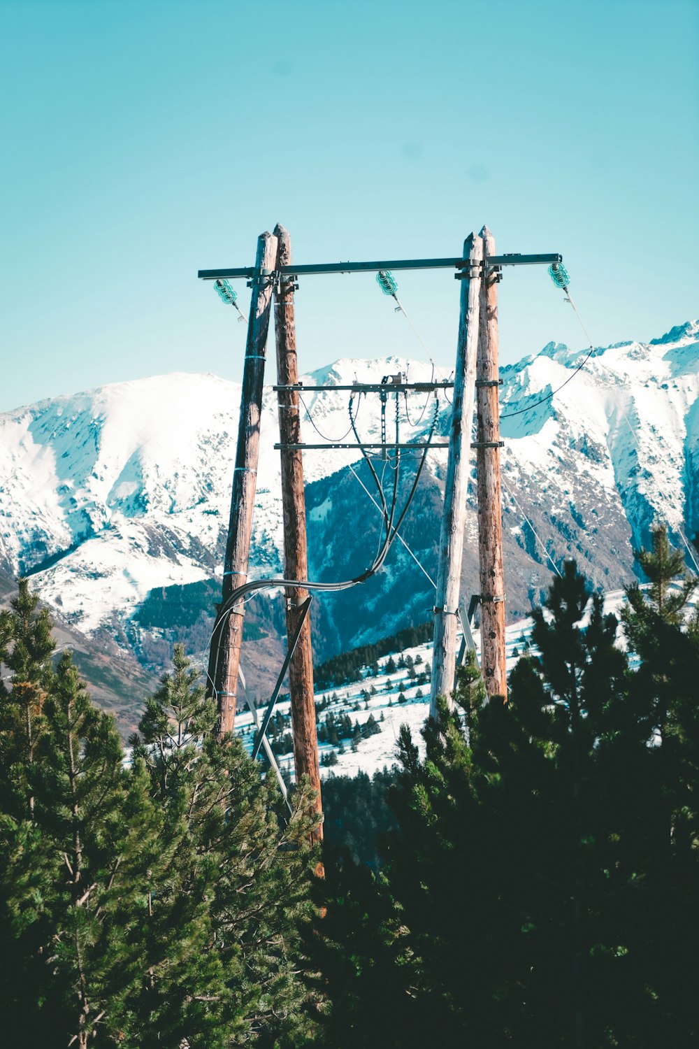 a ski lift in the middle of a snowy mountain range