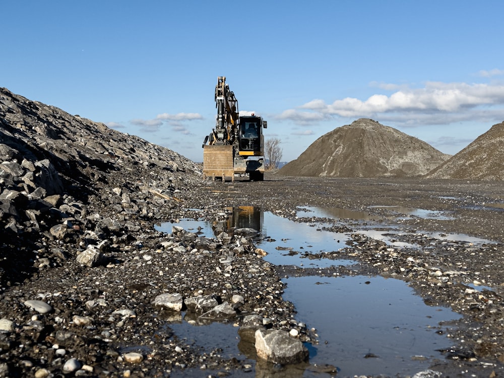 a dump truck driving down a muddy road