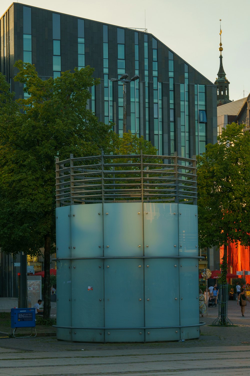 a large metal structure sitting in the middle of a park