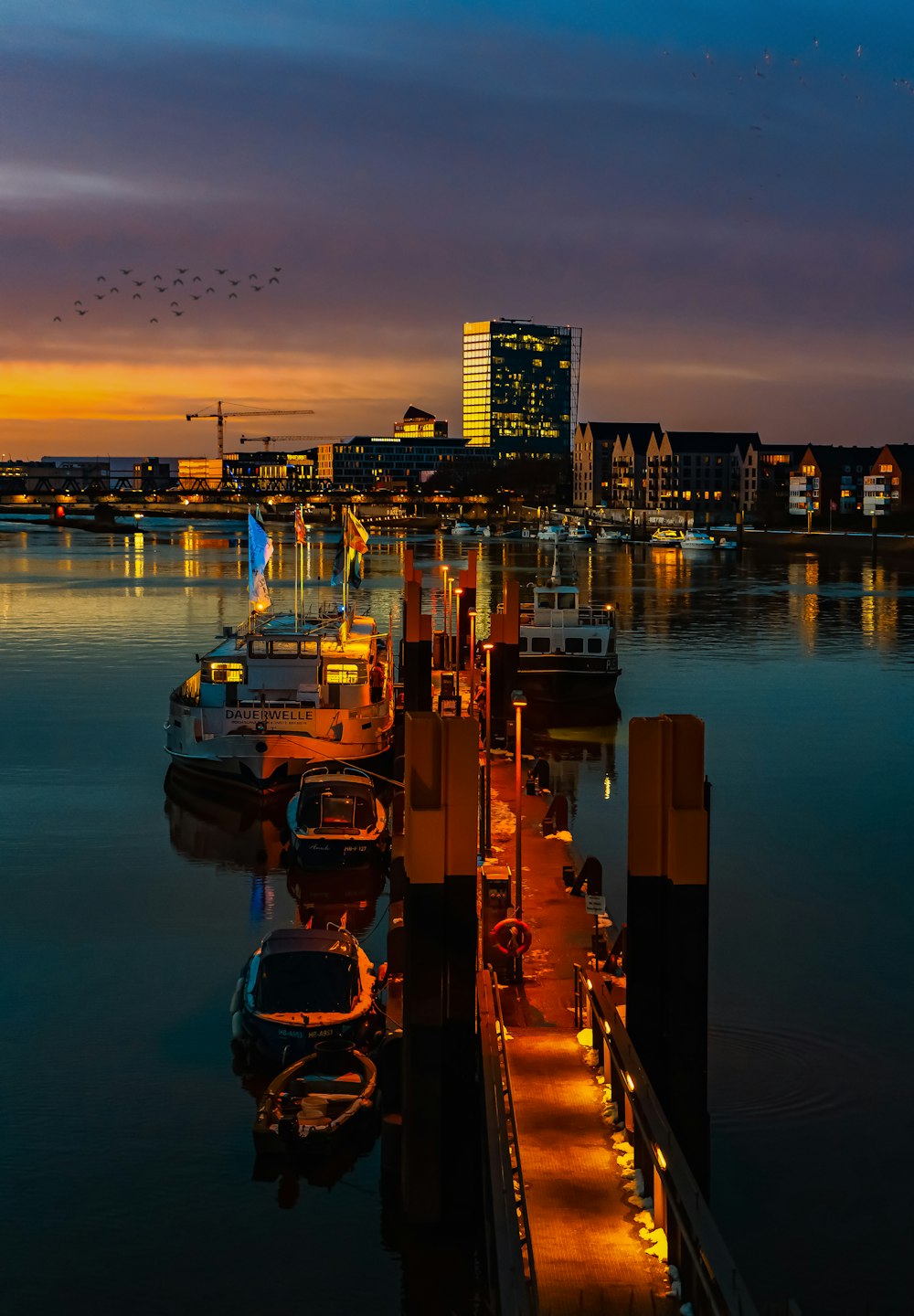 a harbor with boats and a city in the background