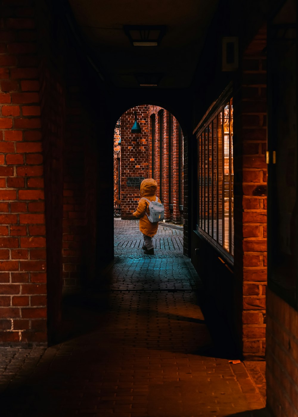 a teddy bear sitting in the middle of a hallway