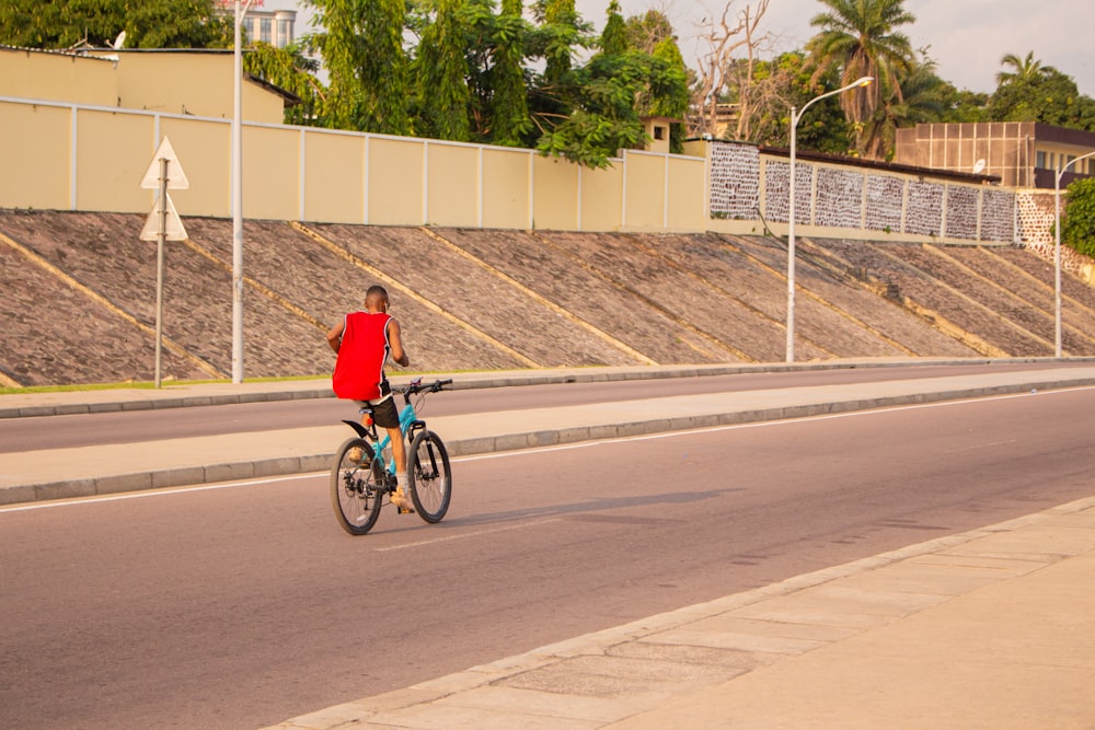 a person riding a bike down a street