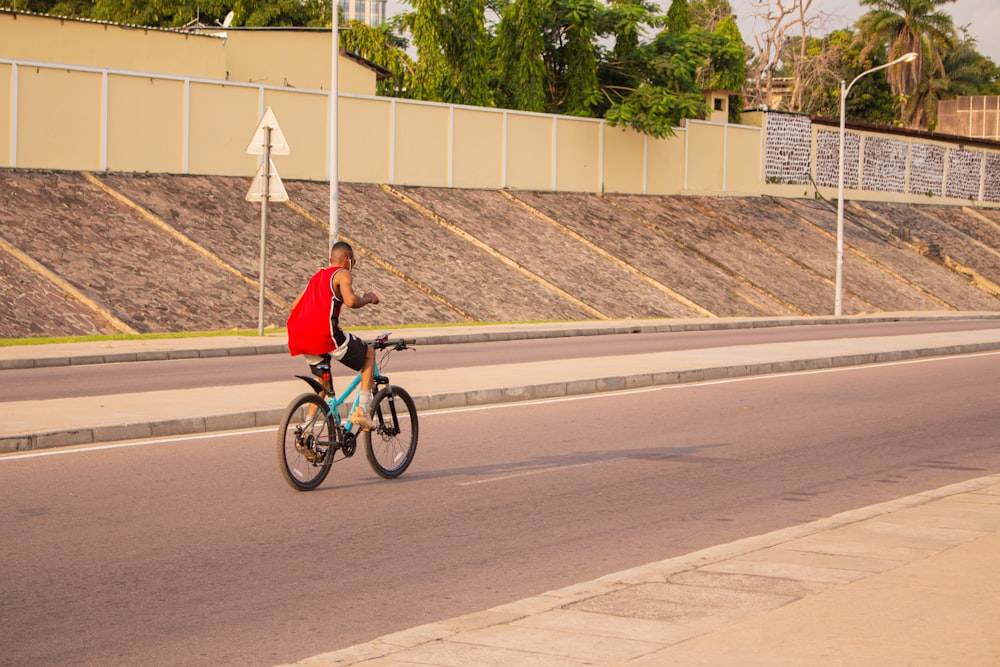 a man riding a bike down a street