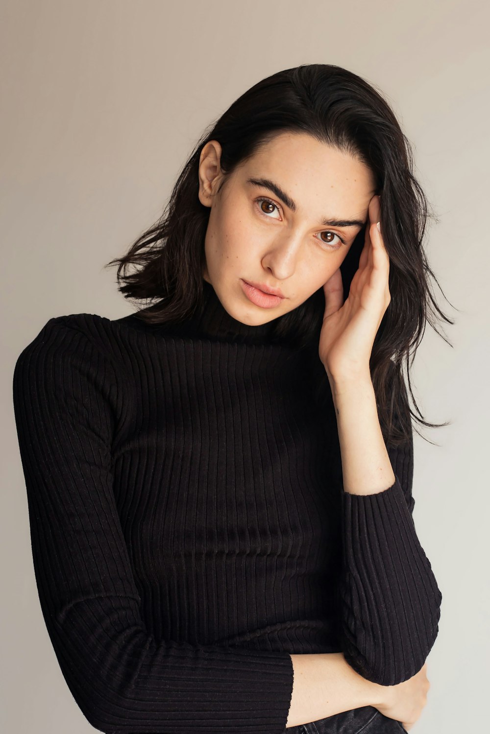 a woman in a black turtle neck sweater