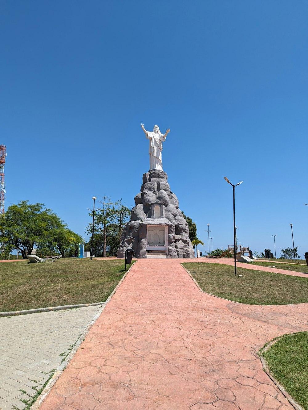 a statue of jesus on top of a hill