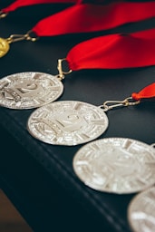 a row of medals with a red ribbon around them