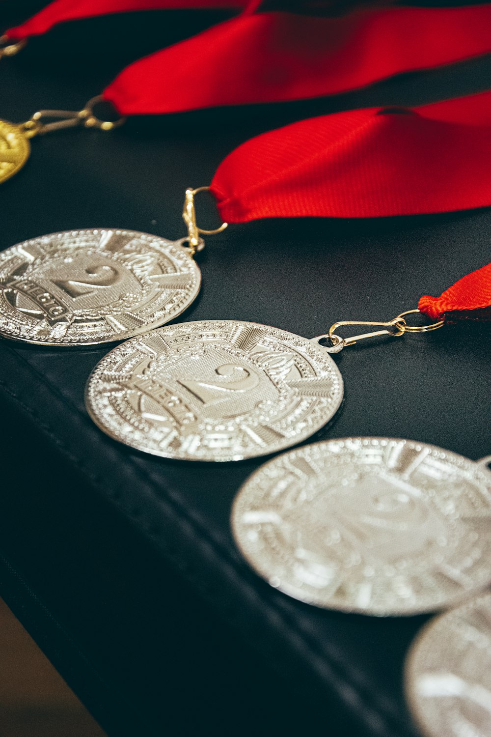 a row of medals with a red ribbon around them