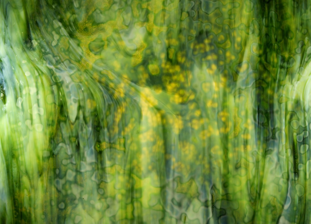 an abstract painting of green and yellow flowers