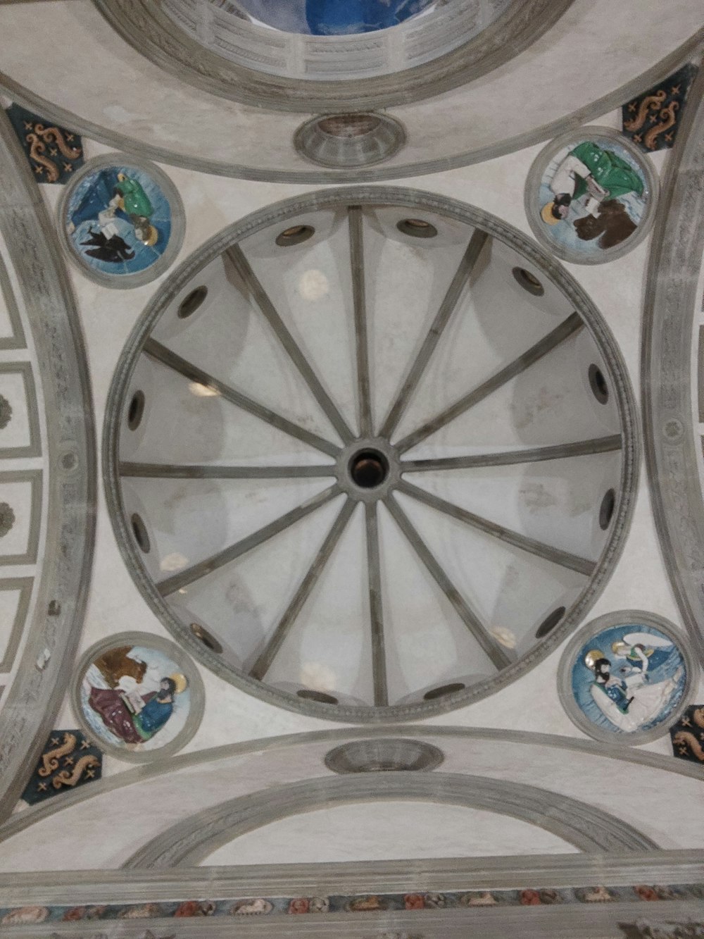 the ceiling of a building with a circular window