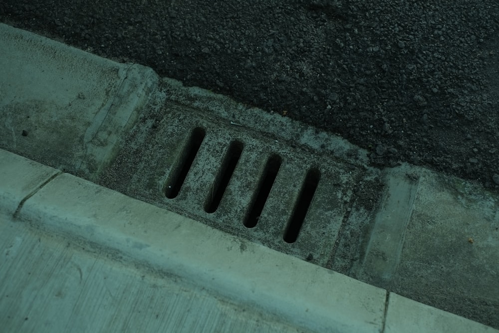 a drain on the side of a road