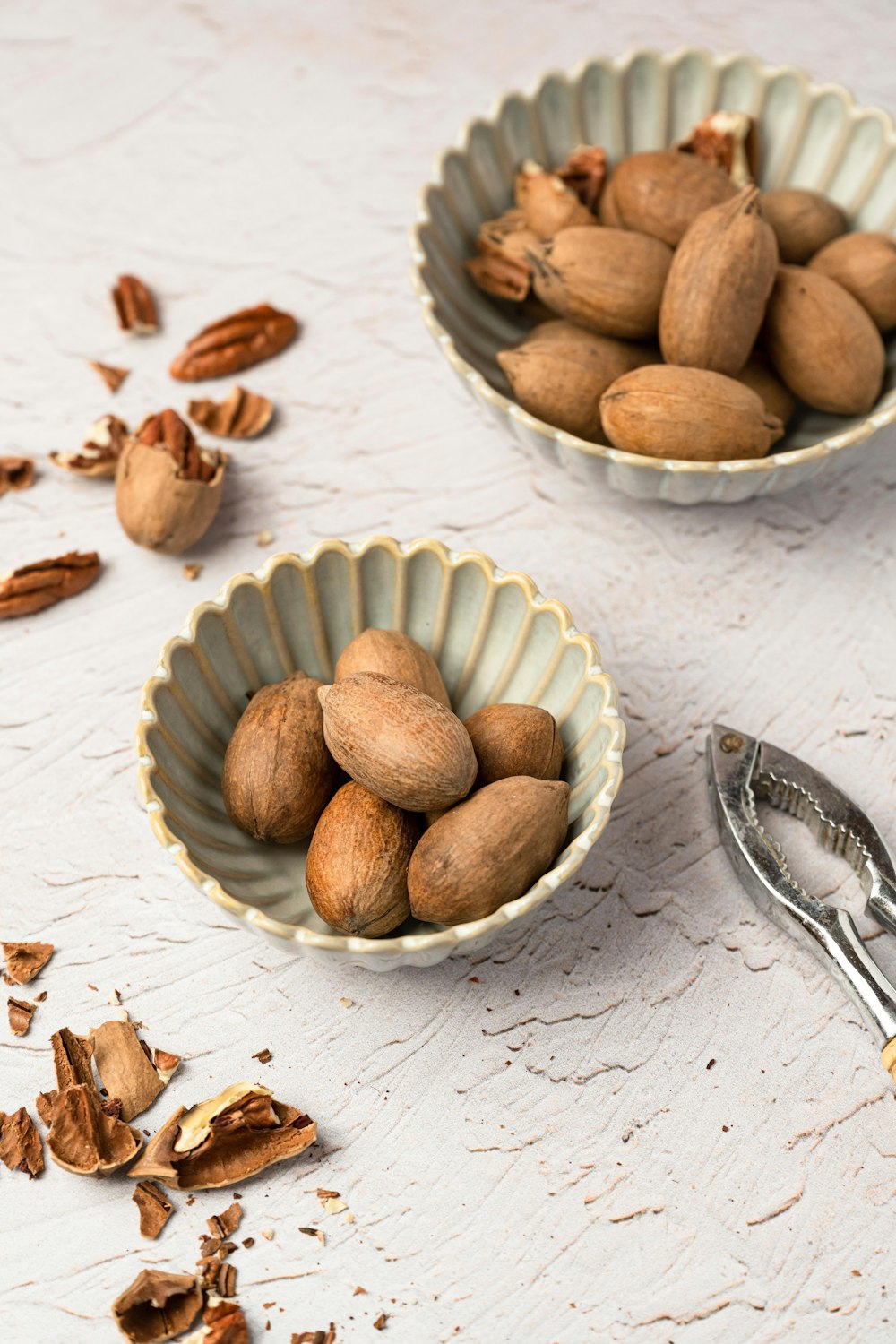 a couple of bowls filled with nuts on top of a table